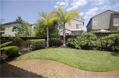 Spacious backyard with lush mature landscaping and