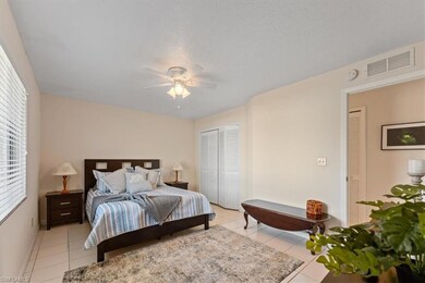 Bedroom featuring a ceiling fan, visible vents, a 