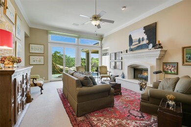 Living area with a glass covered fireplace, ornam