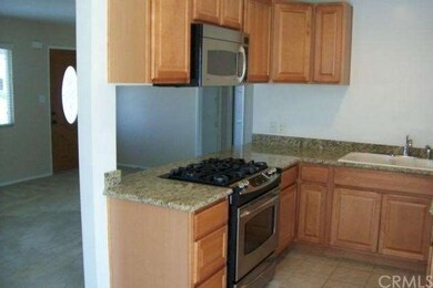 Granite counters and tile flooring in the kitchen.