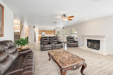 Living room with light wood-style flooring, ceili
