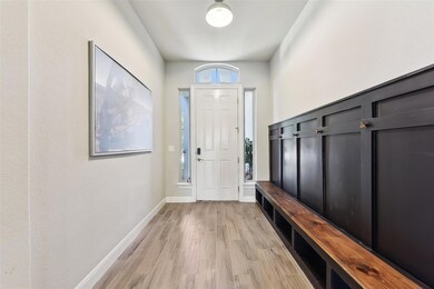 Mudroom featuring light wood-style flooring and b