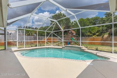 View of pool featuring glass enclosure, a fenced backyard, a patio, and a sunroom