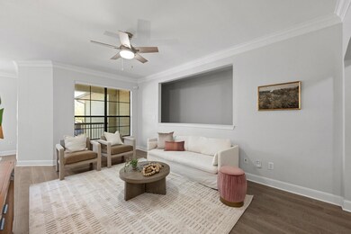 Living area with crown molding, wood finished flo