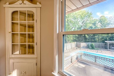 The dining room overlooks the in ground swimming p