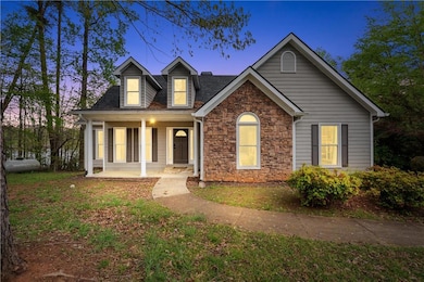 View of front of house with stone siding and cover