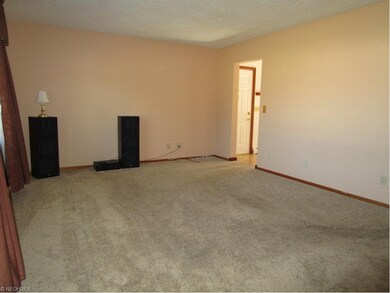 Living room has hardwood flooring under the carpet