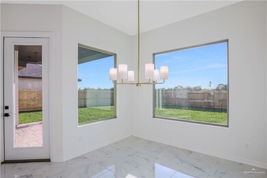 Unfurnished dining area with marble finish floor, baseboards, and a notable chandelier