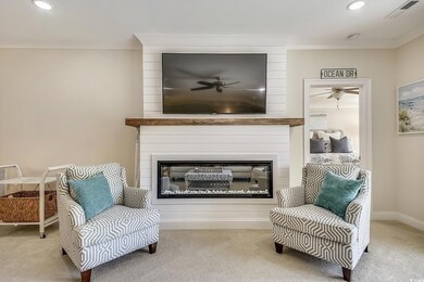 Sitting room with a large fireplace, carpet, a ceiling fan, and recessed lighting