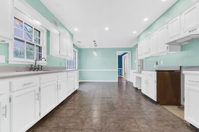 Kitchen featuring a sink, visible vents, and white