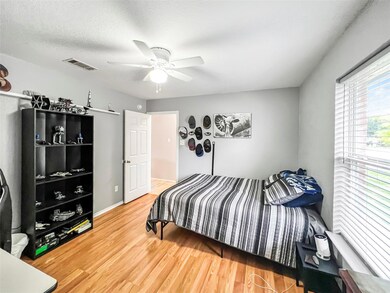 Bedroom featuring wood finished floors and ceilin