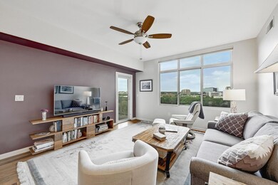Living area with ceiling fan, wood finished floor