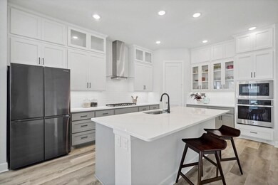 Kitchen featuring Cafe range hood, a center island