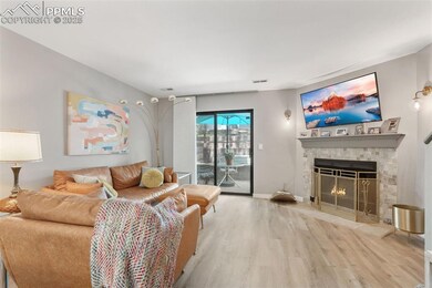 Living room with wood finished floors and a tile fireplace