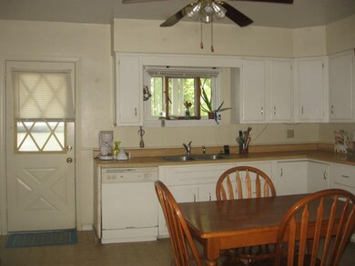 Kitchen.  Door leads to covered back porch.