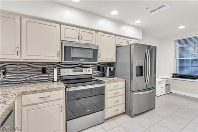Kitchen featuring light tile patterned floors, sta