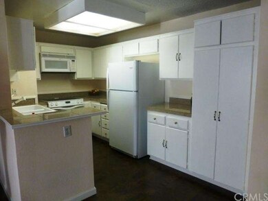 Freshly painted white cabinets and granite counter