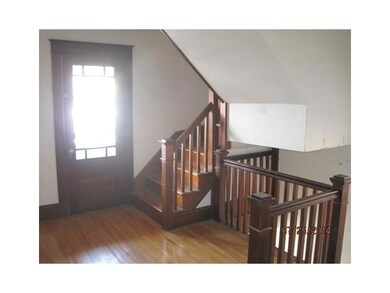 Hallway. Stair case and door to...