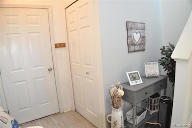 Entry closet and door to attached garage