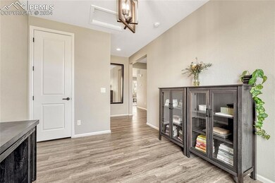 Home office with view of entry hallway leading to 