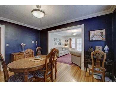 Hardwoods continue to the spacious formal dining r