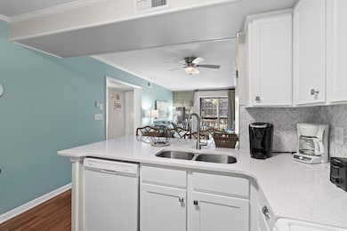Kitchen featuring dishwasher, backsplash, white ca