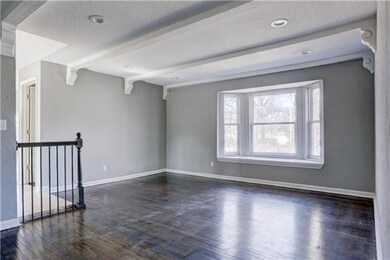 formal living room with original hardwoods and win
