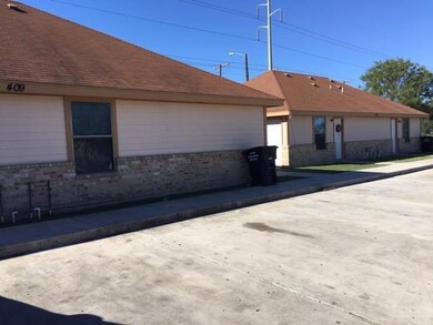 View of side of home featuring brick siding and a shingled roof