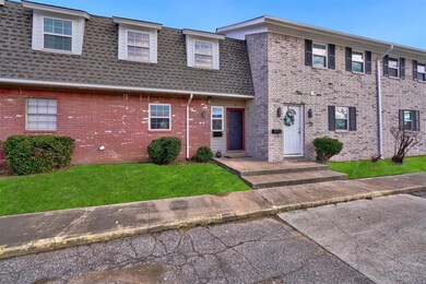 View of property featuring a front lawn