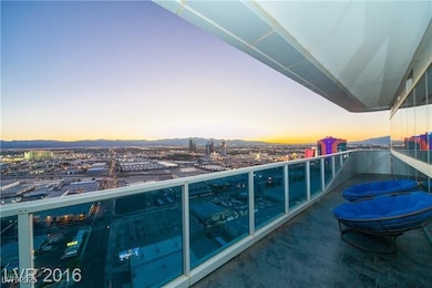 Balcony at dusk featuring a view of city