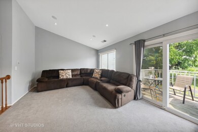 Living Room w/ Vaulted ceiling & Balcony