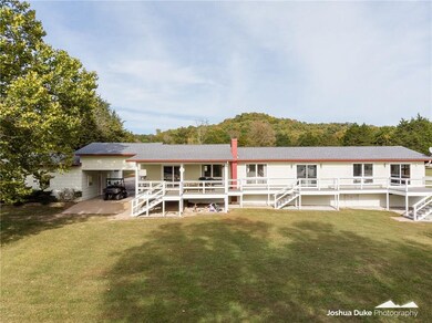 Lakeside view of the house.  Lots of windows to en