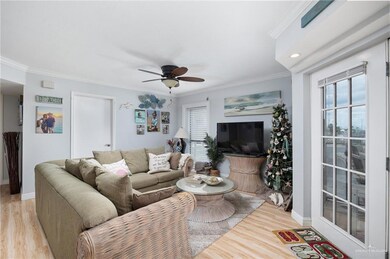 Living room with ceiling fan, light hardwood / wood-style floors, and crown molding
