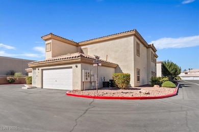 View of property exterior featuring stucco siding, driveway, and a tiled roof