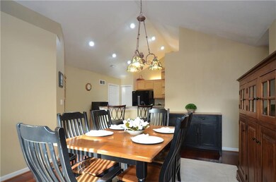 The dining room offers hardwood floors and a vault