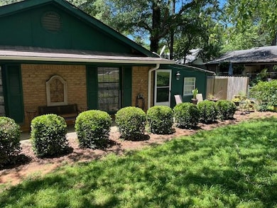 View of property exterior with brick siding and covered porch