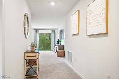 Corridor featuring carpet floors and baseboards