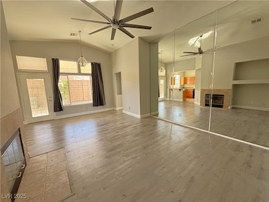 Unfurnished living room with ceiling fan, lofted c