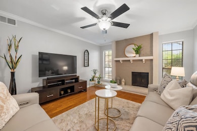 Living area featuring wood finished floors, ornam