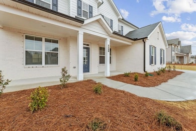 Property entrance featuring brick siding and a por