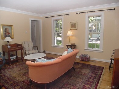 Living room w/ crown molding from dining room