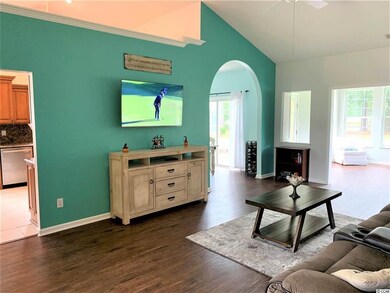 Living room opens into the arched dining area, kit