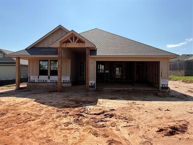 Rear view of property with roof with shingles, board and batten siding, and a garage
