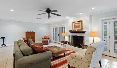 View of living room with fireplace and french door