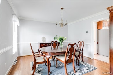 Light and bright dining room with chair rail, and