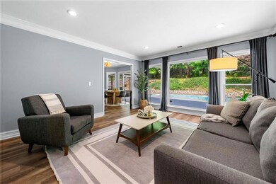 Living area featuring ornamental molding, LVP floo