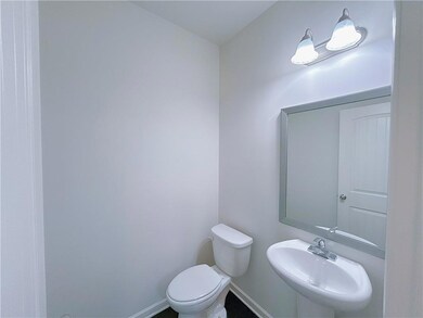 Bathroom featuring a sink and baseboards