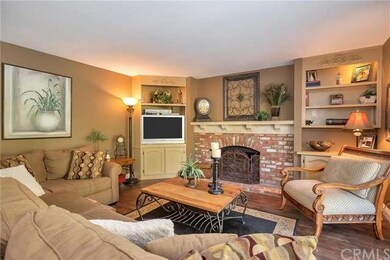 The cozy family room with wood floors, built-ins a