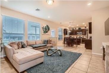 Living area featuring light tile patterned floors and recessed lighting