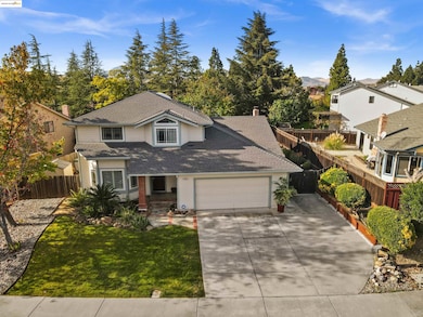 Traditional-style home with concrete driveway, covered porch, roof with shingles, an attached garage, and a chimney